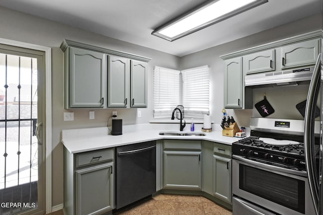 kitchen featuring dishwashing machine, sink, and stainless steel gas range