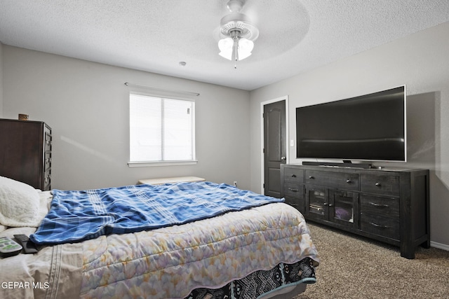 carpeted bedroom with ceiling fan and a textured ceiling