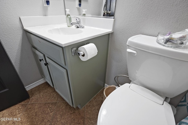 bathroom with vanity, toilet, and tile patterned flooring