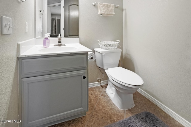 bathroom featuring tile patterned flooring, vanity, and toilet