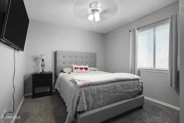 carpeted bedroom featuring ceiling fan and a textured ceiling