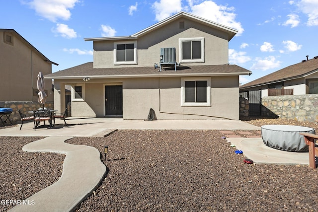 rear view of property featuring cooling unit and a patio