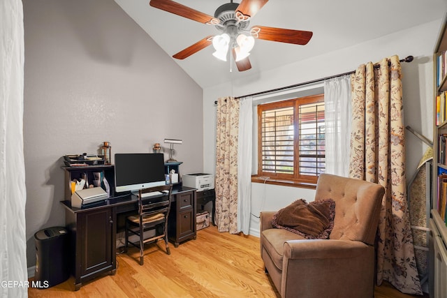 home office with vaulted ceiling, ceiling fan, and light hardwood / wood-style floors