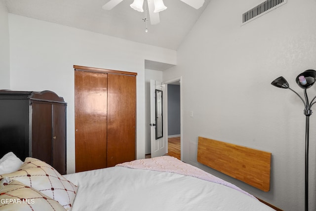 bedroom featuring ceiling fan, lofted ceiling, and a closet