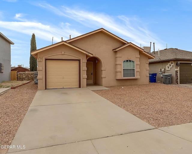 single story home with an attached garage, concrete driveway, and stucco siding