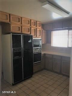 kitchen featuring tile patterned flooring and black appliances