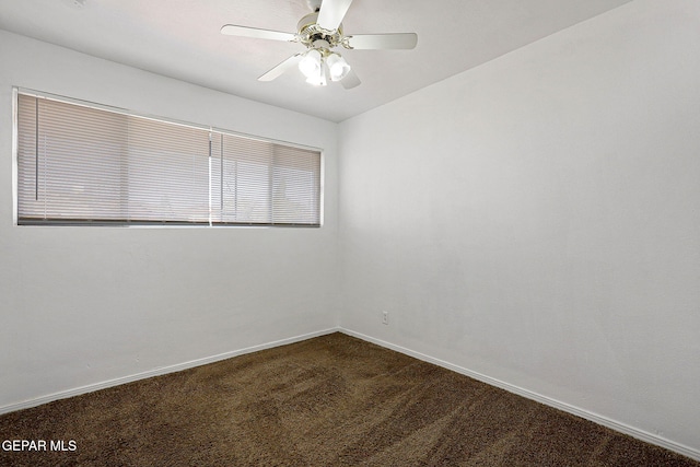 carpeted spare room with ceiling fan and baseboards