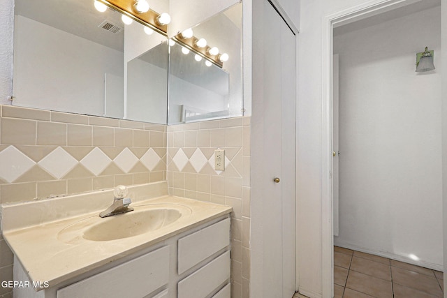 bathroom featuring tile patterned flooring, visible vents, vanity, and decorative backsplash