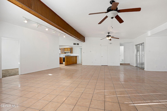 unfurnished living room featuring light tile patterned floors, track lighting, visible vents, and beam ceiling