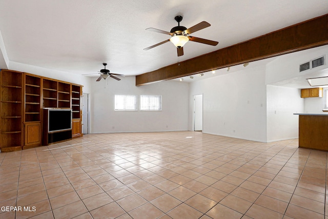 unfurnished living room with light tile patterned floors, visible vents, ceiling fan, a textured ceiling, and baseboards