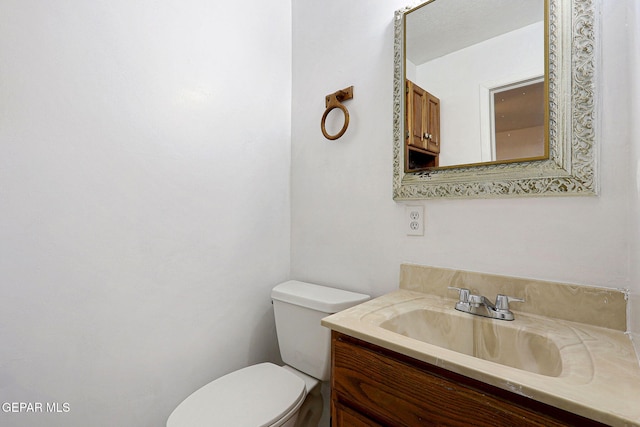 bathroom featuring toilet and vanity