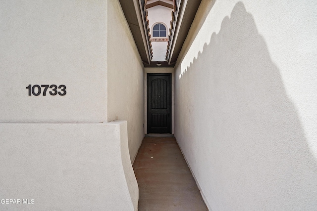 entrance to property featuring stucco siding