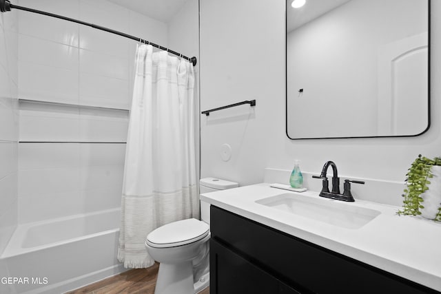 bathroom with shower / bath combination with curtain, vanity, toilet, and wood finished floors