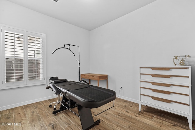 interior space featuring baseboards and wood finished floors