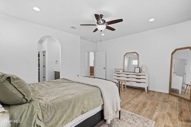 bedroom featuring arched walkways, ceiling fan, recessed lighting, visible vents, and light wood finished floors