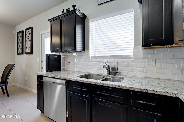 kitchen featuring sink, light tile patterned floors, stainless steel dishwasher, light stone countertops, and backsplash