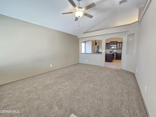 unfurnished living room featuring lofted ceiling, light carpet, and ceiling fan