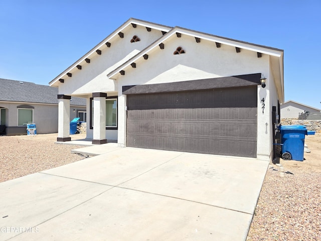 pueblo revival-style home featuring a garage