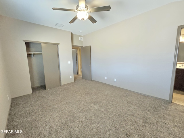 unfurnished bedroom with ceiling fan, connected bathroom, carpet floors, and a closet