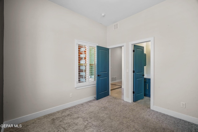 unfurnished bedroom with light colored carpet