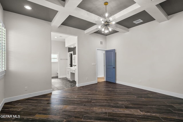 empty room with beamed ceiling, coffered ceiling, a notable chandelier, and dark hardwood / wood-style flooring