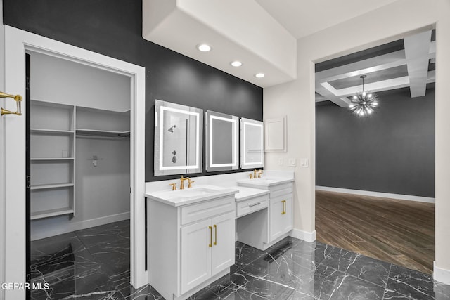 bathroom featuring coffered ceiling, vanity, beam ceiling, and a chandelier