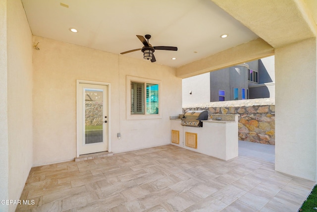 view of patio / terrace with exterior kitchen and a grill