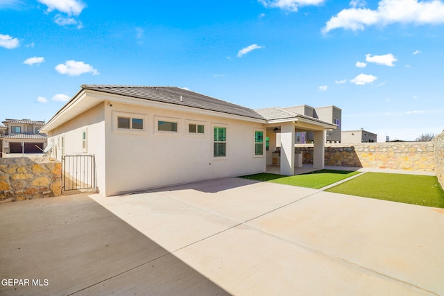 rear view of property featuring a patio area