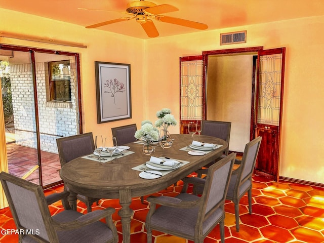 dining space with tile patterned floors and ceiling fan