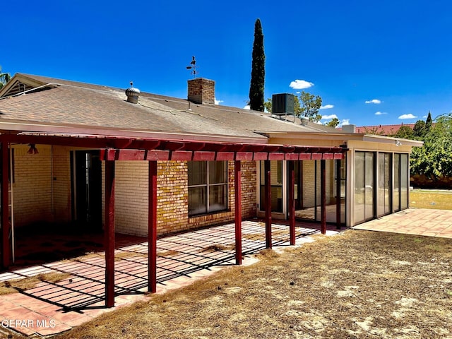 rear view of property with central AC and a patio area