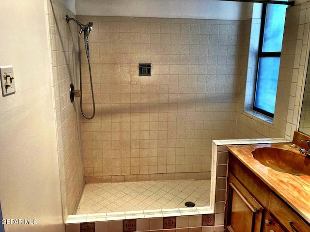 bathroom featuring vanity and a tile shower