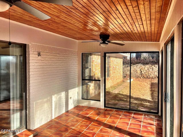 unfurnished sunroom featuring wooden ceiling and ceiling fan