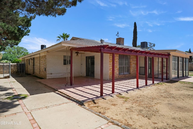 11204 Bob Mitchell Dr, El Paso, TX 79936 - exterior space featuring a chimney, brick siding, fence, a patio, and ceiling fan