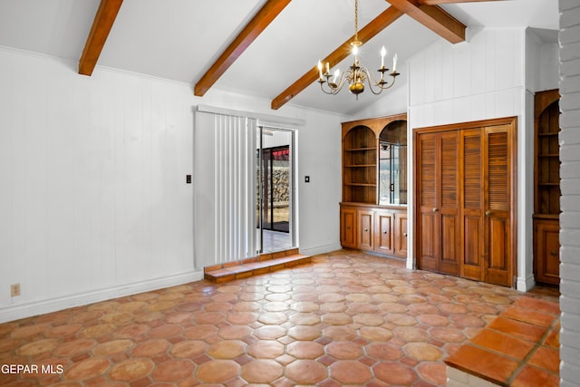 11204 Bob Mitchell Dr, El Paso, TX 79936 - interior space with an inviting chandelier, wooden walls, lofted ceiling with beams, and baseboards