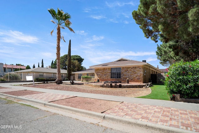 11204 Bob Mitchell Dr, El Paso, TX 79936 - single story home with brick siding, a front lawn, and fence