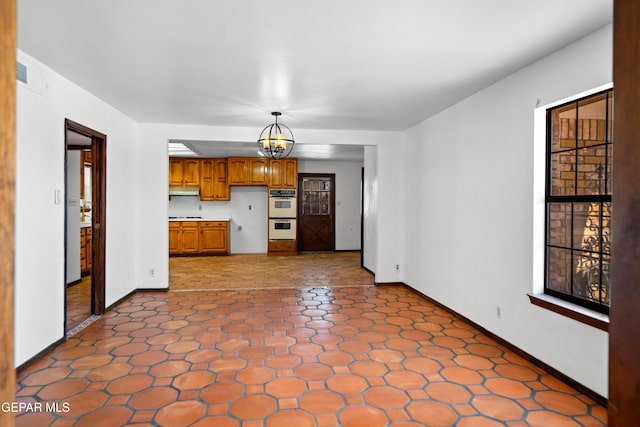 11204 Bob Mitchell Dr, El Paso, TX 79936 - unfurnished living room with a chandelier, baseboards, and dark floors