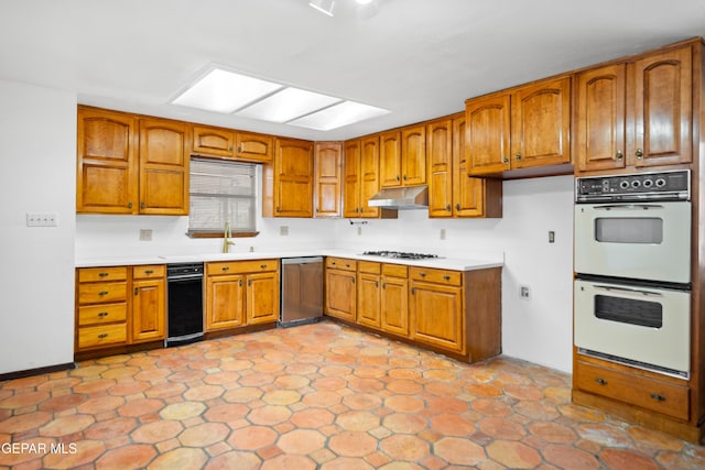 11204 Bob Mitchell Dr, El Paso, TX 79936 - kitchen with brown cabinetry, gas stovetop, double oven, and dishwasher