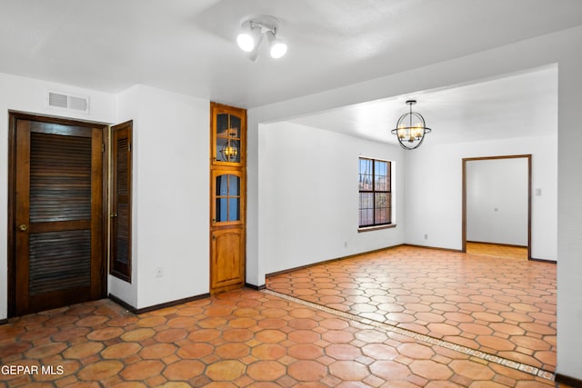 11204 Bob Mitchell Dr, El Paso, TX 79936 - unfurnished room featuring baseboards, a notable chandelier, and visible vents