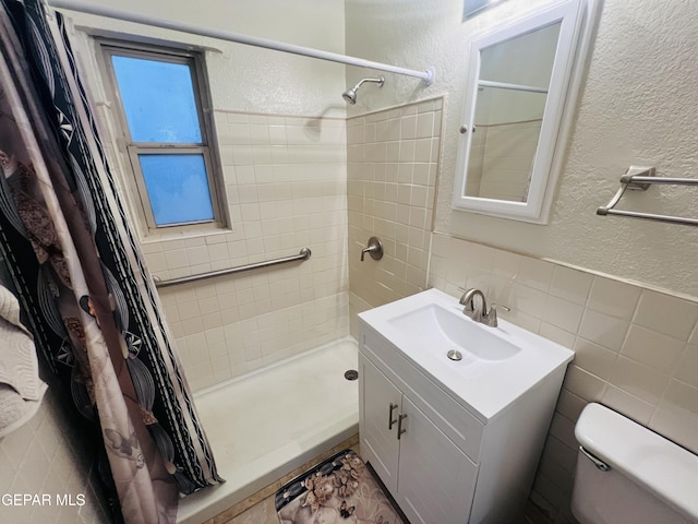 bathroom featuring tile walls, vanity, a shower with curtain, and toilet