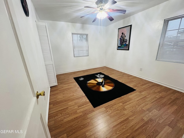 unfurnished room with ceiling fan and wood-type flooring