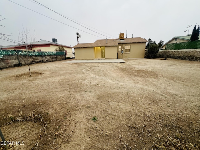 back of house with a patio