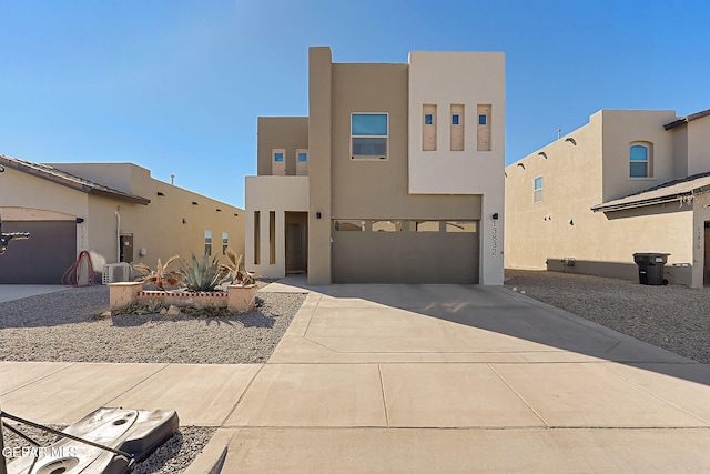 pueblo revival-style home with a garage