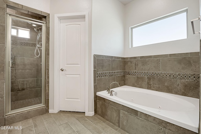 bathroom with separate shower and tub