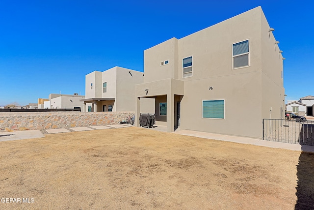 back of property featuring a patio