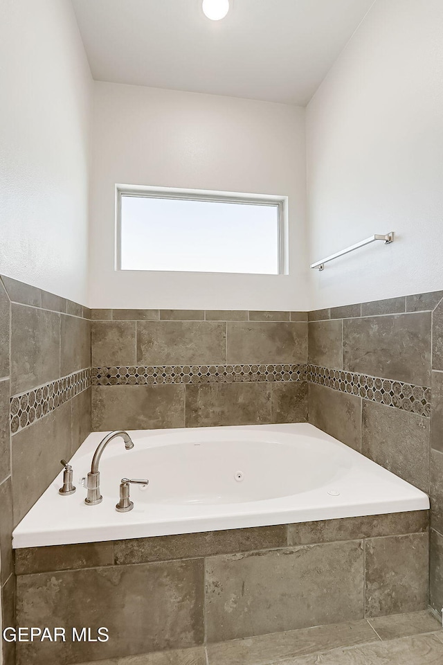 bathroom featuring tiled tub