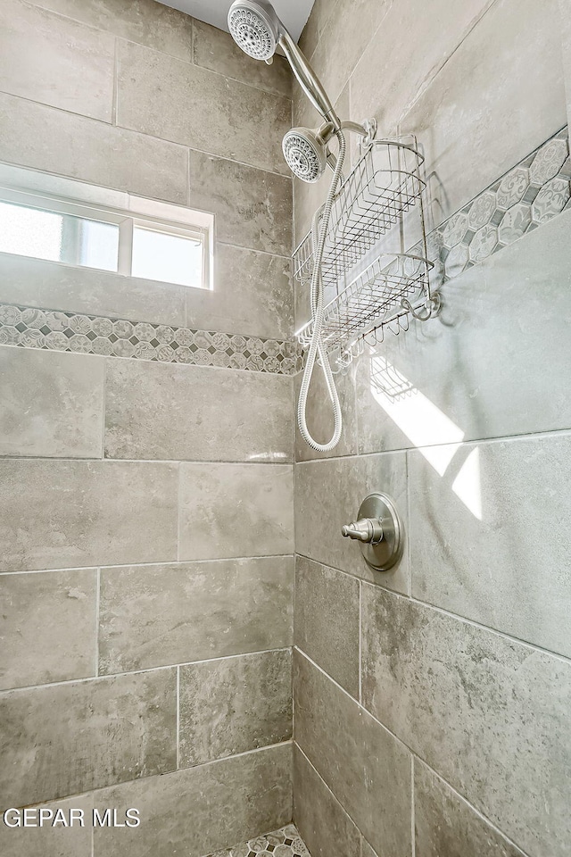 bathroom with a tile shower