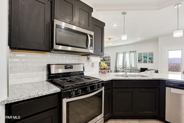 kitchen featuring tasteful backsplash, sink, a healthy amount of sunlight, and appliances with stainless steel finishes