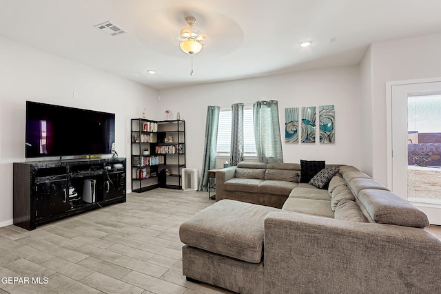 living room featuring light hardwood / wood-style floors and ceiling fan