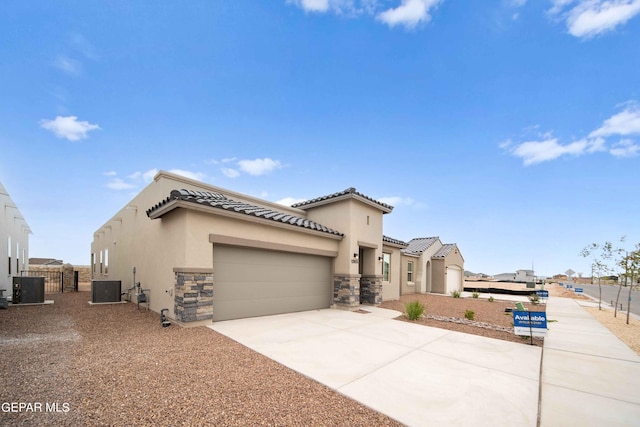 view of front of home with cooling unit and a garage