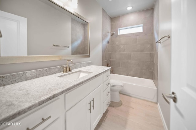 full bathroom featuring vanity, toilet, and tiled shower / bath